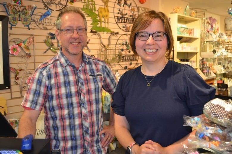 Joey (left) and Danielle Roy (right) are standing at the cash register in Authentique, the store they co-own together.