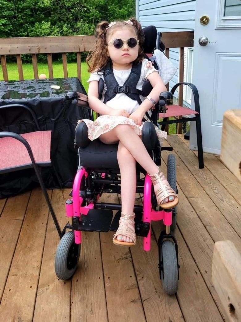 A girl in a wheelchair.