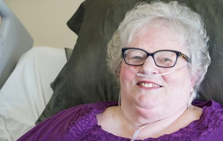 Portrait of woman with oxygen tubes to nose (nasal cannula)