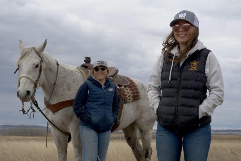 Mackenzie and Taylor L'Heureux with their horse on their grandparent's farm in North Battleford, Sask.