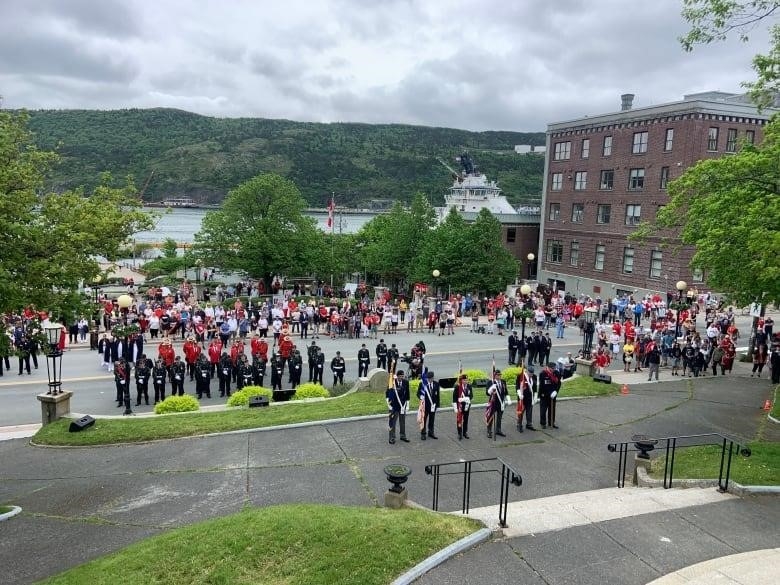 A military marching band stands aside the National War Memorial in downtown St. John's. Dozens of wreaths lay at the base of the monument.