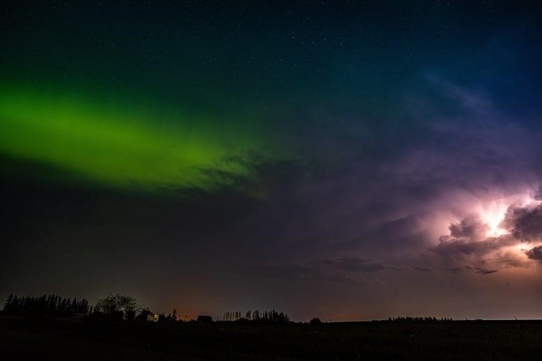 The night sky can be seen with the stunning green northern lights on one side and thunder and lightning on the other side.