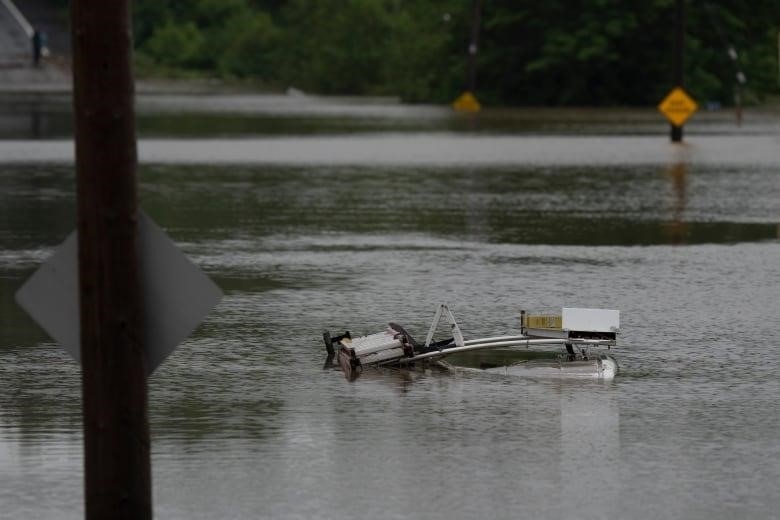 The top of a service truck is seen abandoned in floodwater following a major rain event in Halifax on Saturday, July 22, 2023.