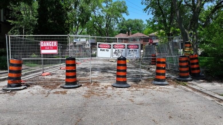 Pilons and gating block off a portion of Old Mill Drive where work continues to rescue multi-million dollar boring machine trapped below the surface.