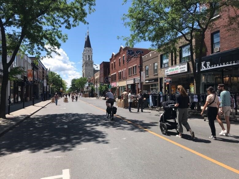 People are in the middle of the street. 