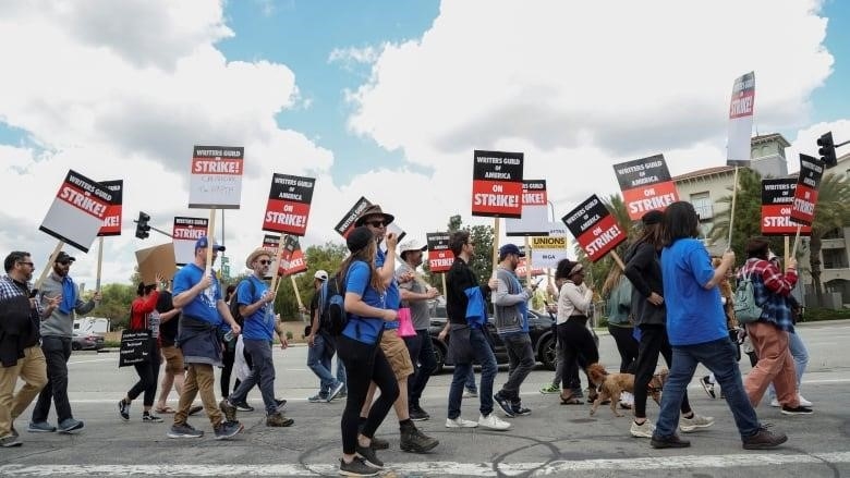 Hollywood writers picket over pay and AI restrictions.
