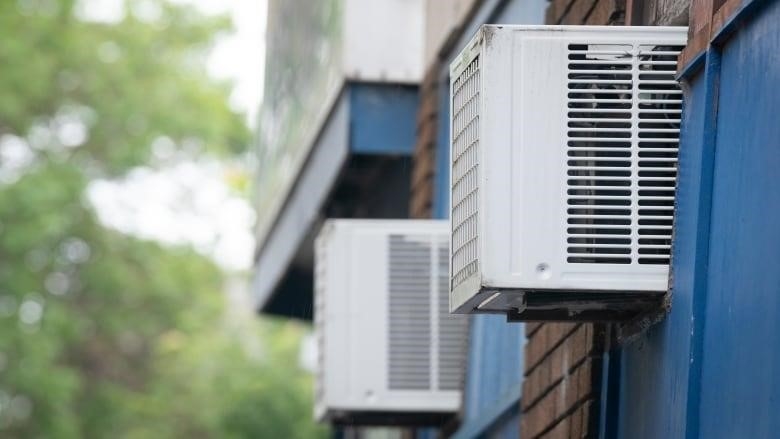 STOCKSHOTS. Air conditioners in windows of an apartment in Montreal on 31 Jul 2023.