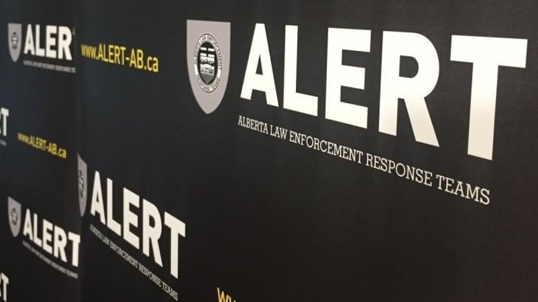 Wall with ALERT logo and sign mural for Alberta Law Enforcement Response Teams.