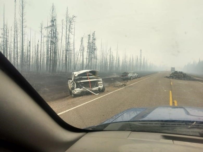 Burned vehicles on the highway outside Enterprise, N.W.T. on Monday.