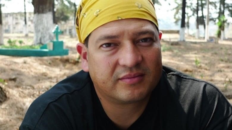 Fredy Peccerelli, director of the Forensic Anthropology Foundation of Guatemala posing for a picture in a cemetary