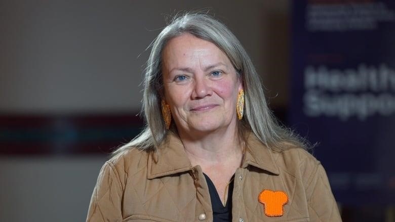 Posed, smiling photo of Kimberly Murray, from the shoulders up.