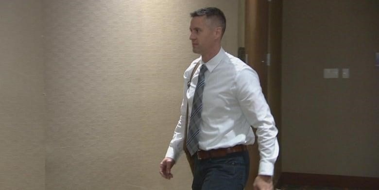 Scott Gullacher walking outside a room at his disciplinary hearing