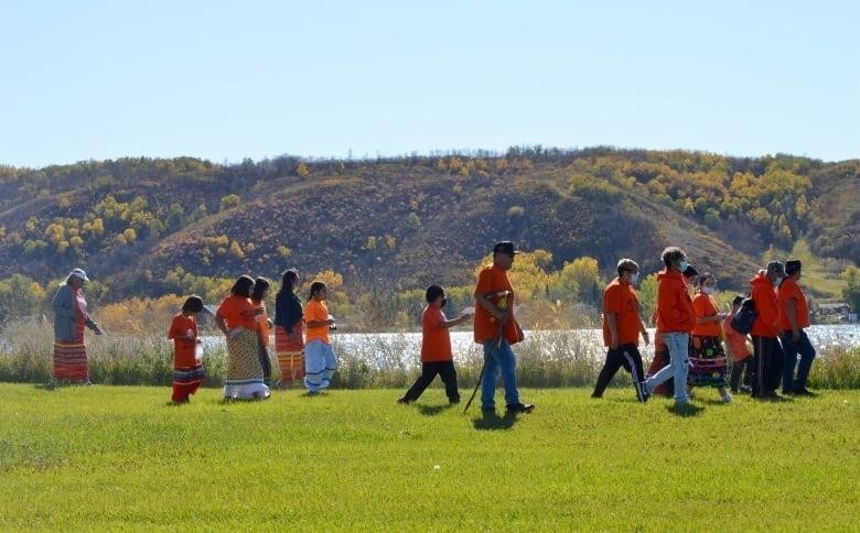 Members of Star Blanket Cree Nation take part in a smudge walk around the grounds of the former Lebret Indian Industrial School in Lebret, Sask., 