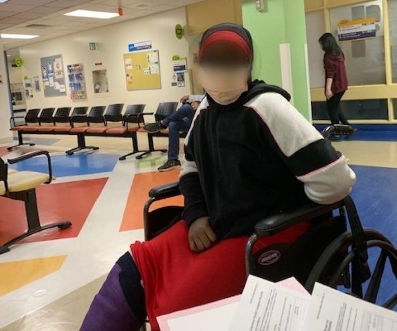 12-year-old in a wheelchair, face blurred.