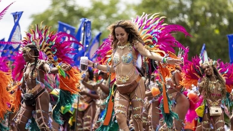 Scenes of dancers in costumes from the 55th Toronto Caribbean Carnival's Grand Parade at the Exhibition Place on July 30, 2022.